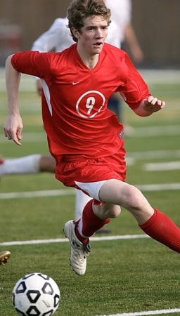 soccer player running with the ball